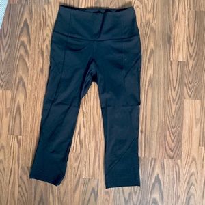 Black Lululemon Cropped Legging with Laser Cutout Detailing at Bottom